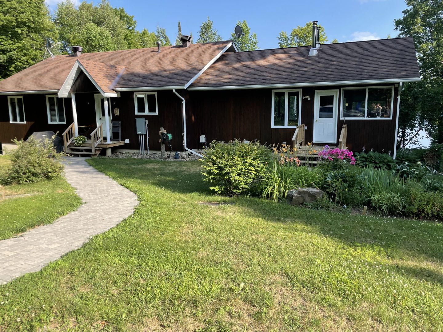 $729K for a Hardwood Lake cottage with an old-timey woodstove and a waterfront garden
