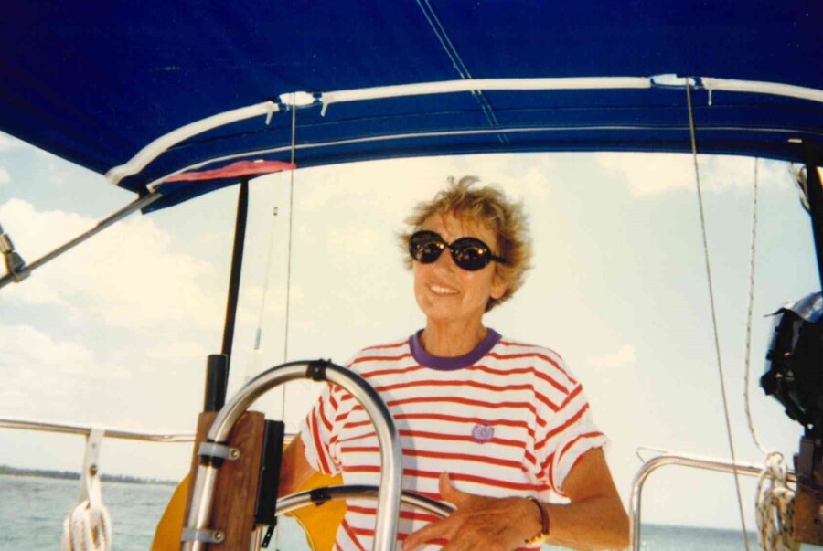Marny Pugh at the helm of she and Bob's sail boat.